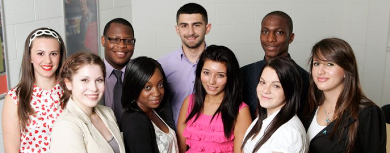 Group of diverse students smiling, representing the inclusive community at East London College.