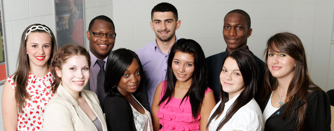 Group of diverse students smiling, representing the inclusive community at East London College.