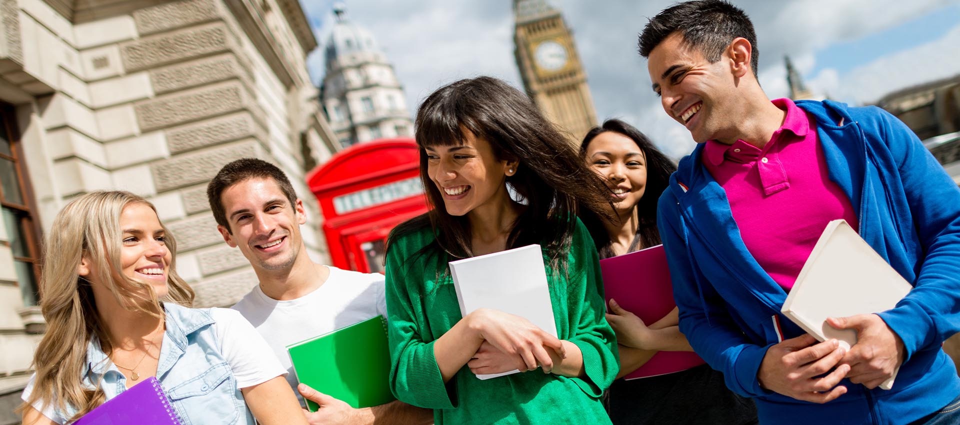 Group of students smiling and walking near iconic London landmarks, representing student life at East London College.