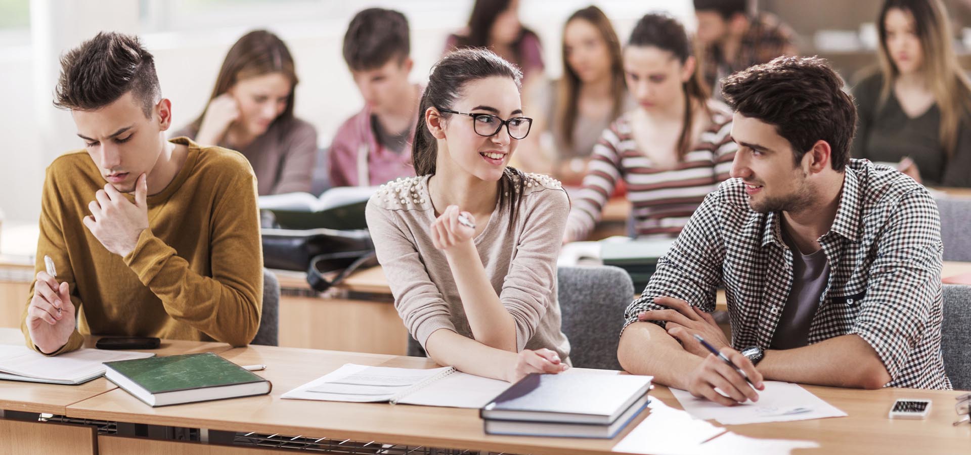 Students collaborating in a classroom, engaged in group work, representing learning in higher education.