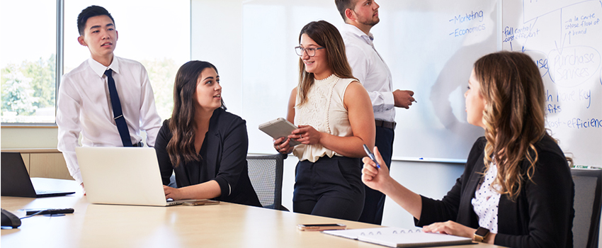 Group of students collaborating in a classroom, representing teamwork and learning in a Bachelor's Degree program.