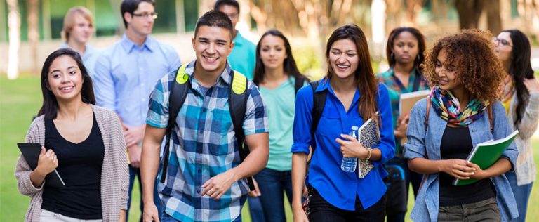 Group of students walking on campus, representing those pursuing a Bachelor Degree in higher education.