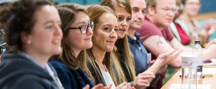 Group of students applauding in a classroom, representing engagement in HND courses.