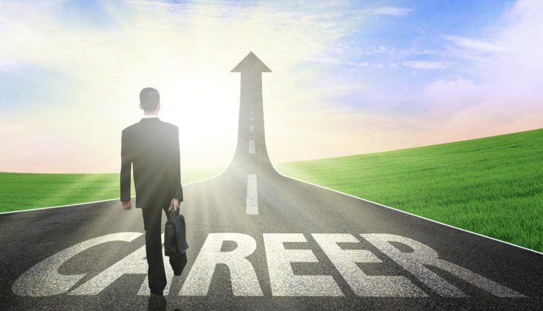 A businessman walking on a road labeled 