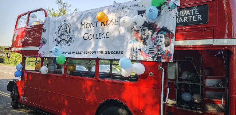 A decorated red double-decker bus adorned with balloons and a Mont Rose College banner for the Mont Rose College Graduation Ceremony 2024.