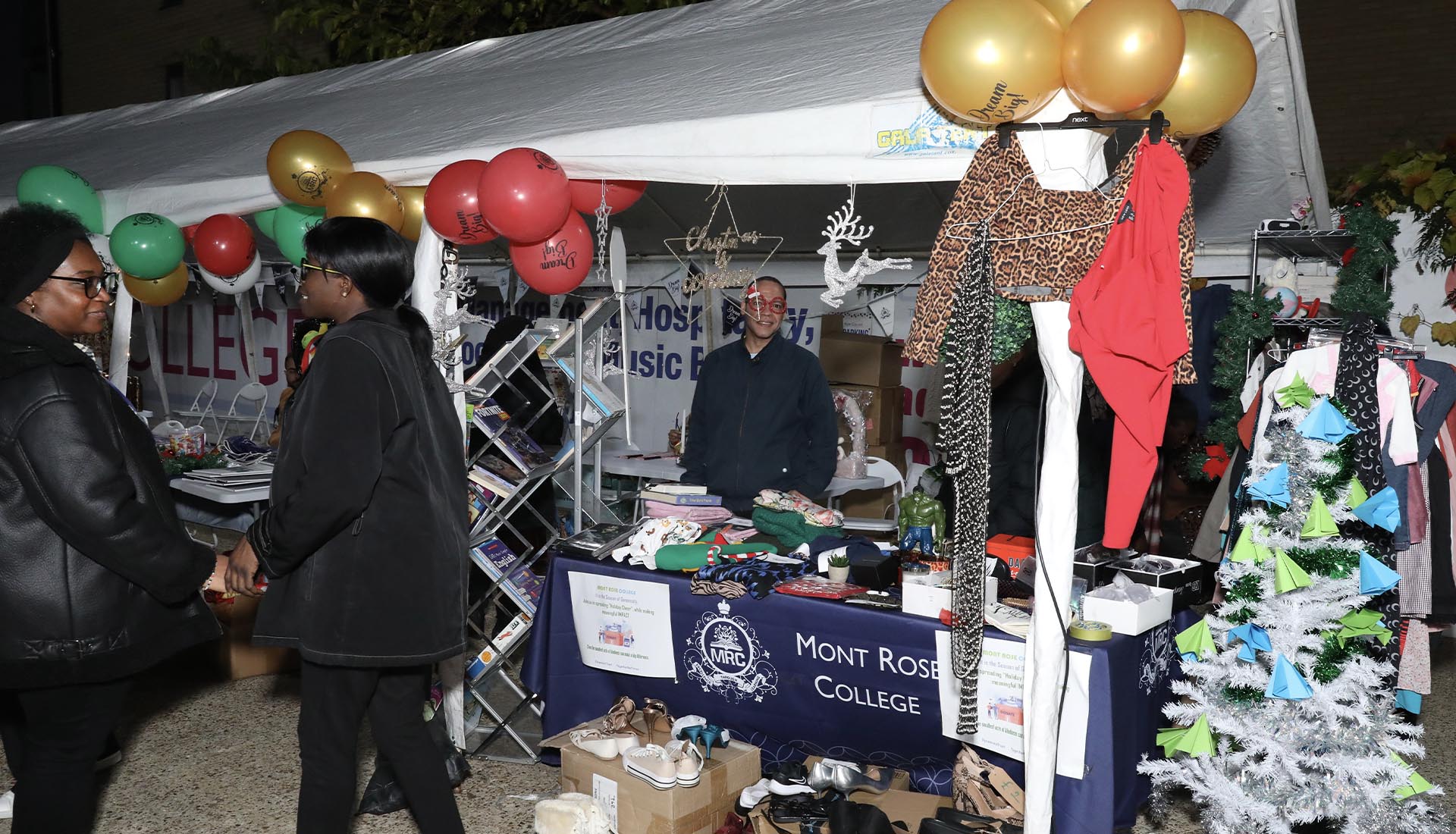 A festive stall at the Mont Rose College Christmas Fair 2024, showcasing clothes, decorations, and holiday-themed items.