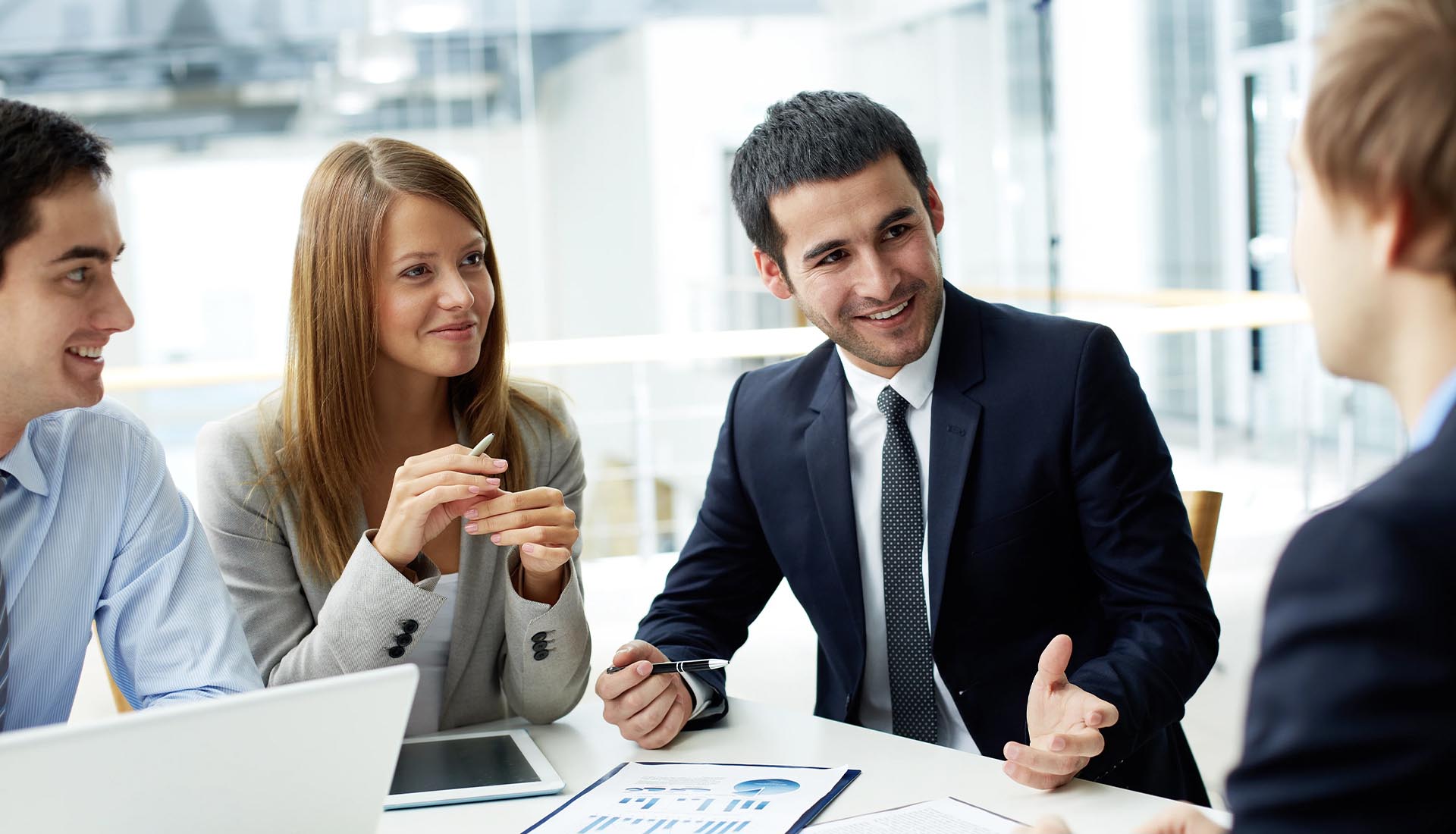 A professional team discussing reports in a modern office, showcasing how to elevate your career with an HND qualification.