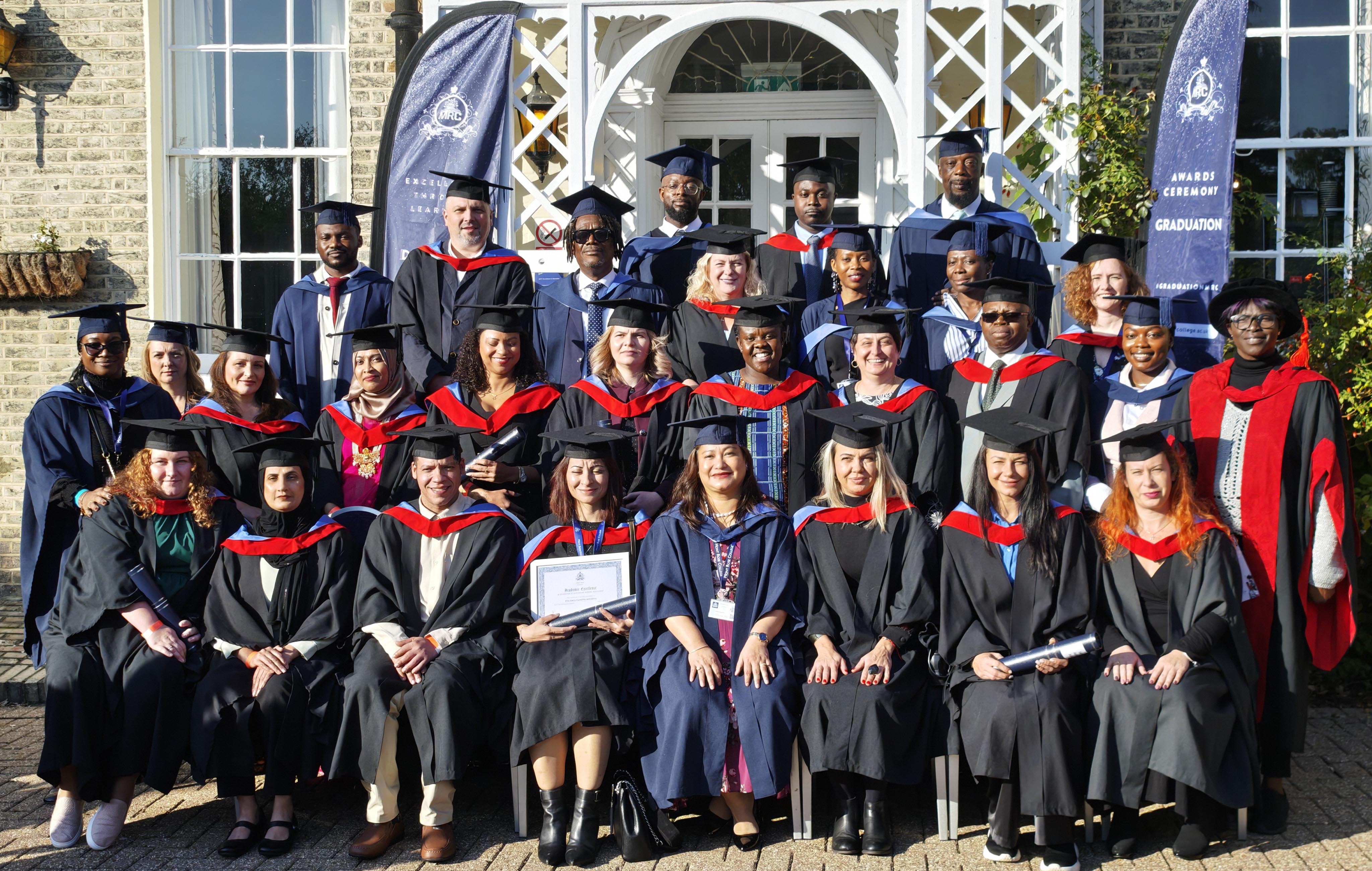 Graduates in caps and gowns pose for a group photo outdoors during the Mont Rose College Graduation Ceremony 2024.