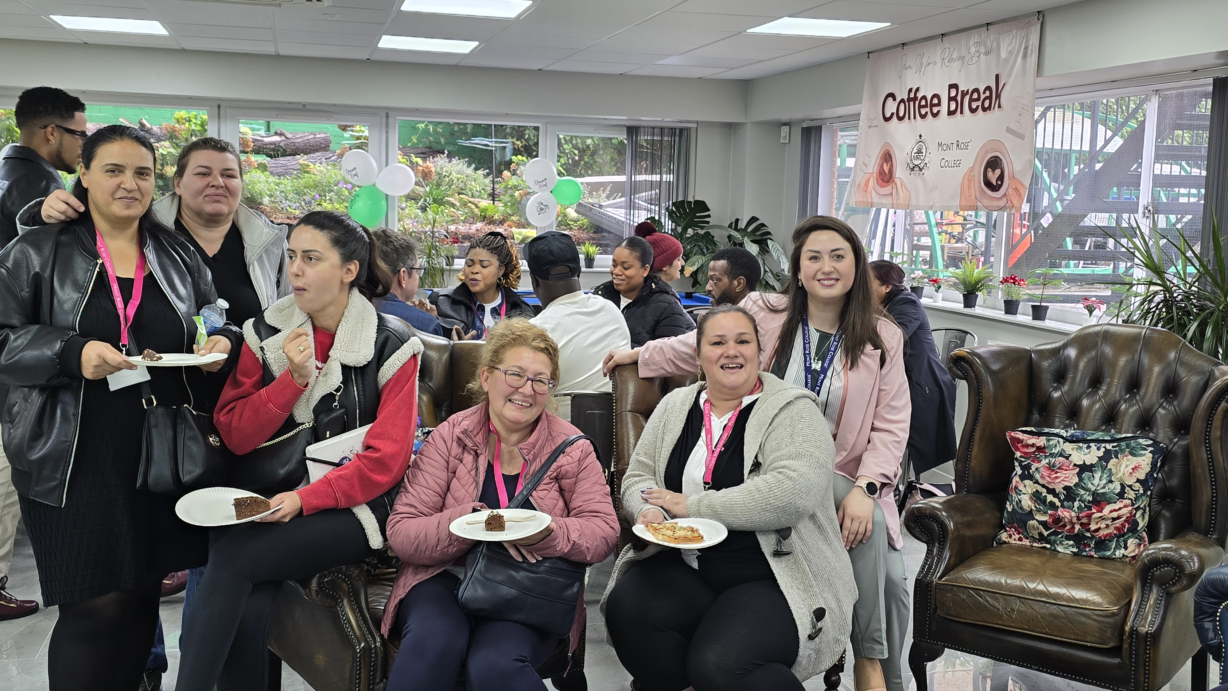 Group enjoying refreshments at Mont Rose College Macmillan Charity Event with