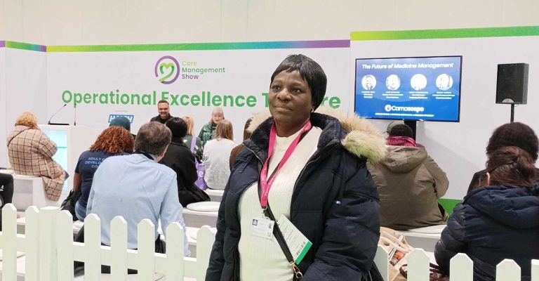 Woman attending the Care Management Show, standing near the Operational Excellence Theatre during a session on the Future of Medicine Management.