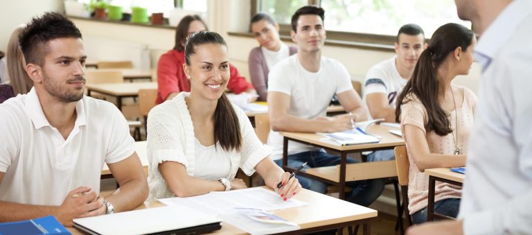 Students attentively listening in a classroom, showcasing active learning and engagement in HND Programs