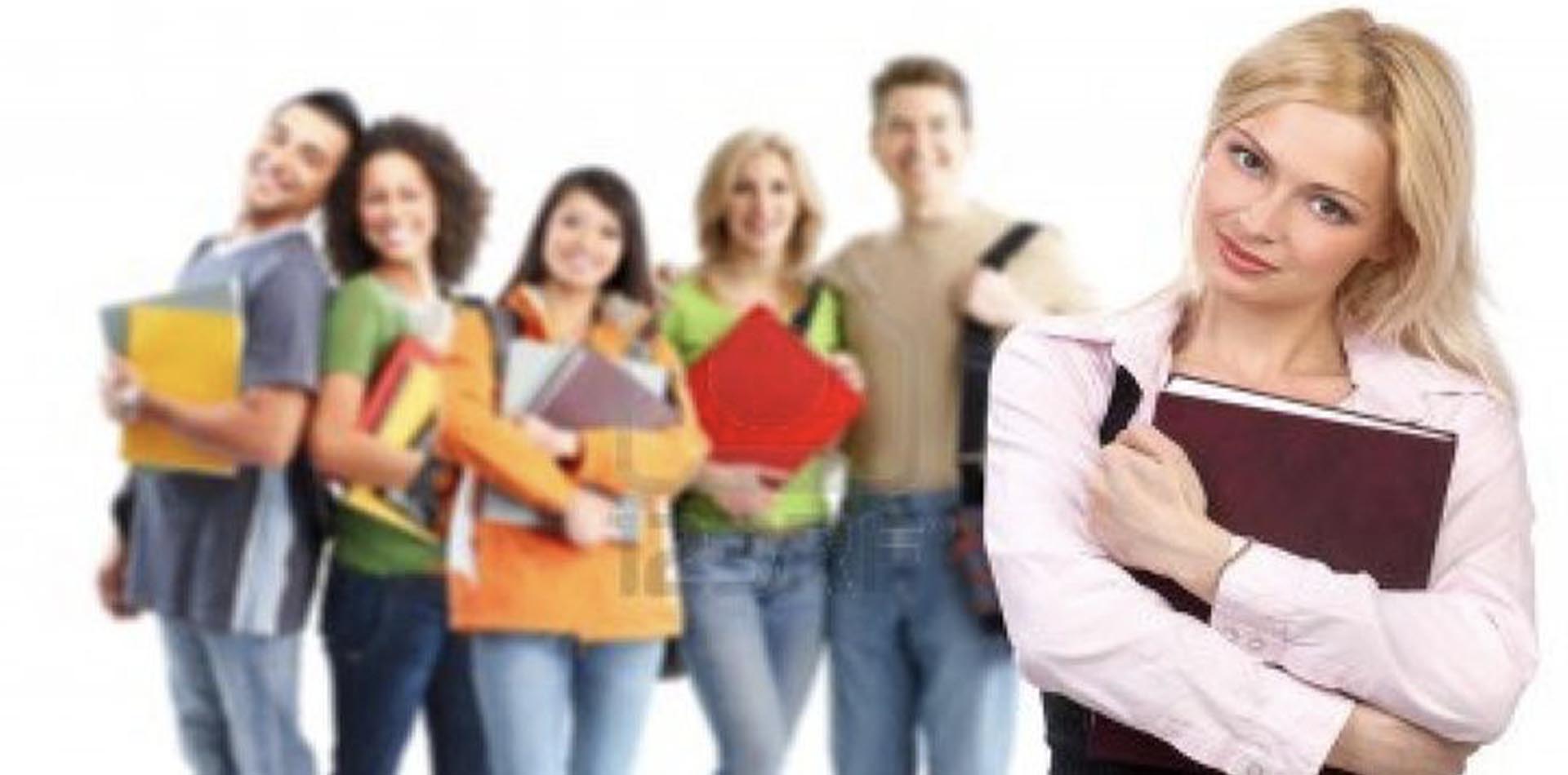 Group of diverse students holding books and folders, with one student in the foreground smiling confidently, emphasizing the Importance of Accreditation for HNDs, set against a bright, neutral background.