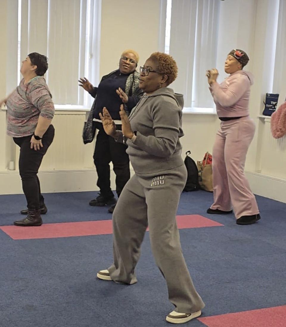 A group of women dancing and enjoying a fitness session. Zumba Fusion Fitness Meets Fun at Mont Rose College promotes movement and joy.