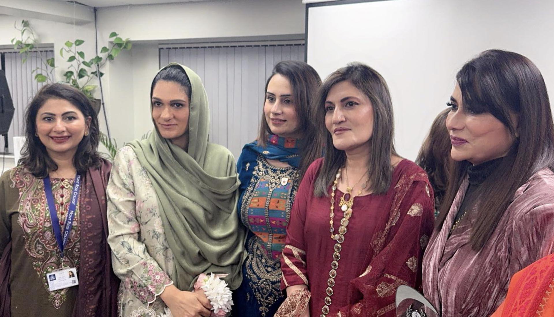 A group of women in traditional attire smiling at Celebrating International Women's Day at Mont Rose College, honoring achievements and empowerment.