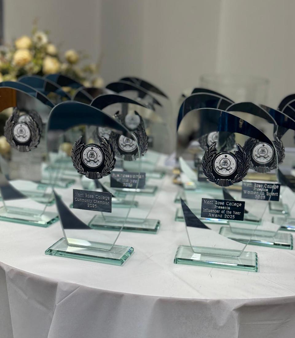 A table displaying awards at Celebrating International Women's Day at Mont Rose College, recognizing achievements and contributions of inspiring women.