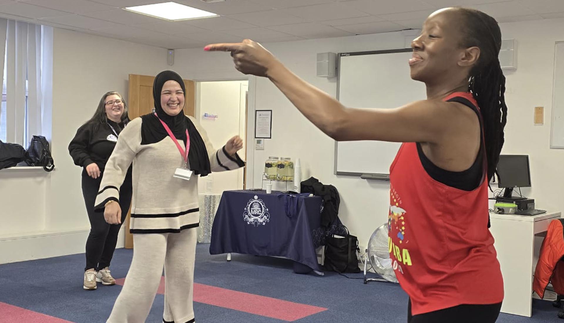 A Zumba instructor leads a joyful dance session with participants. Zumba Fusion Fitness Meets Fun at Mont Rose College energizes everyone.