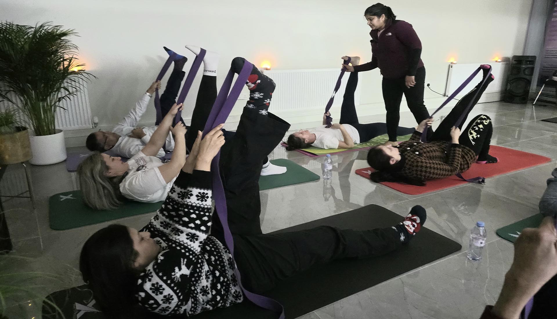 Participants engaging in a guided stretching session during Yoga at Mont Rose College, promoting relaxation and well-being.