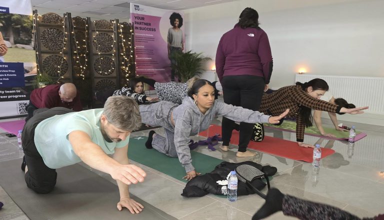 Participants practicing balance and core exercises during Yoga at Mont Rose College, fostering mindfulness and well-being in a serene setting.