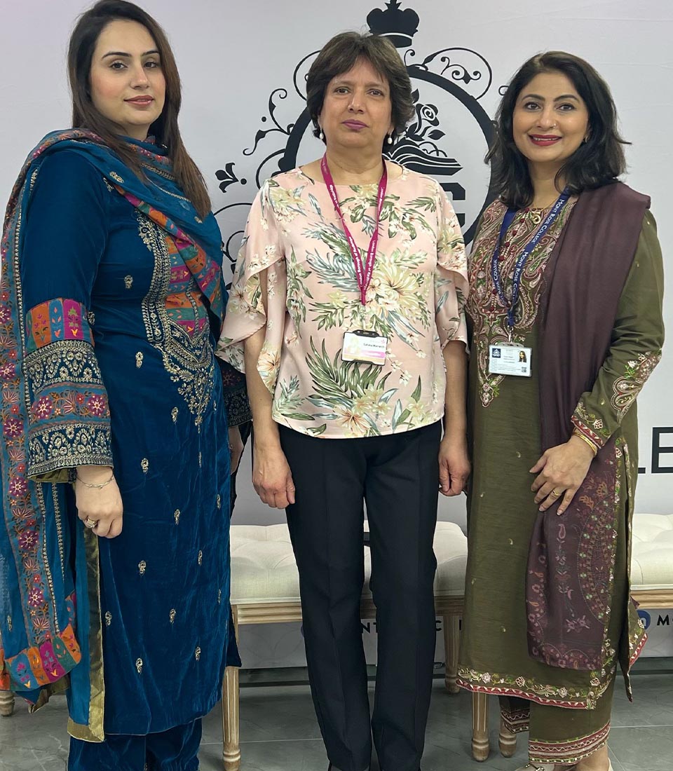 Three women pose together at Celebrating International Women's Day at Mont Rose College, honoring achievements and empowerment.