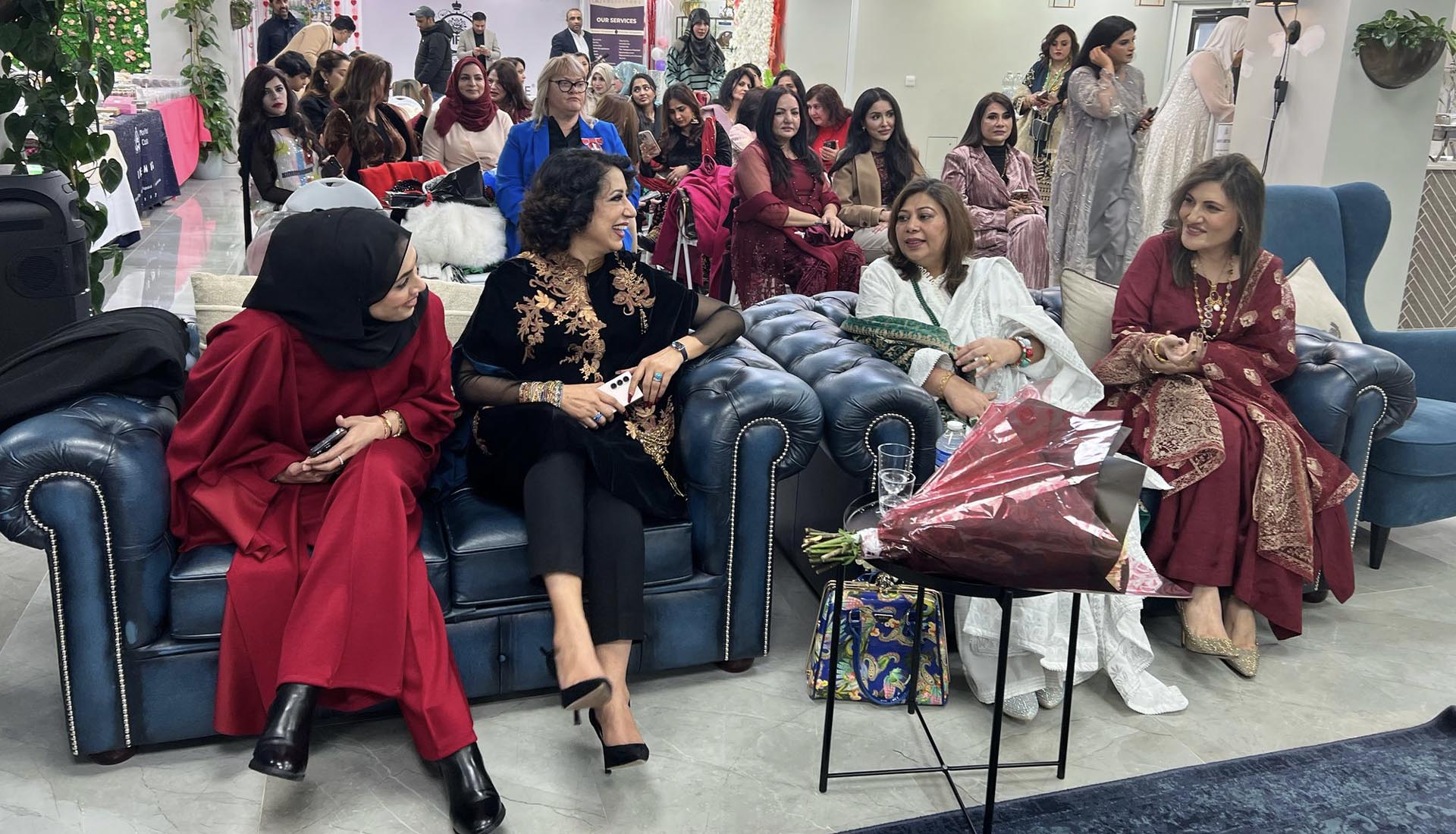Women in elegant attire engaging in conversation at Celebrating International Women’s Day at Mont Rose College, honoring achievements and empowerment.