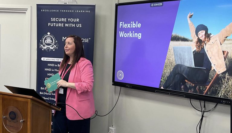A woman presents a talk on flexible working at Mont Rose College for International Women’s Day celebration.