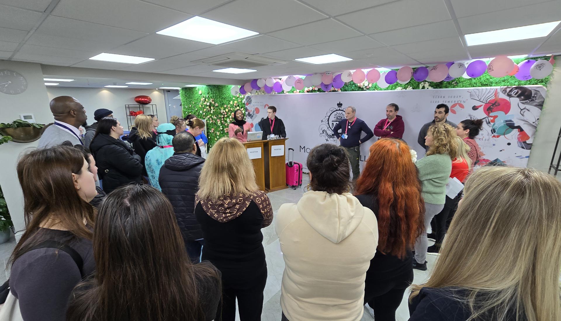 Group of students and staff gathered during a Hospitality Practical Workshop at Mont Rose College, with presenters speaking.