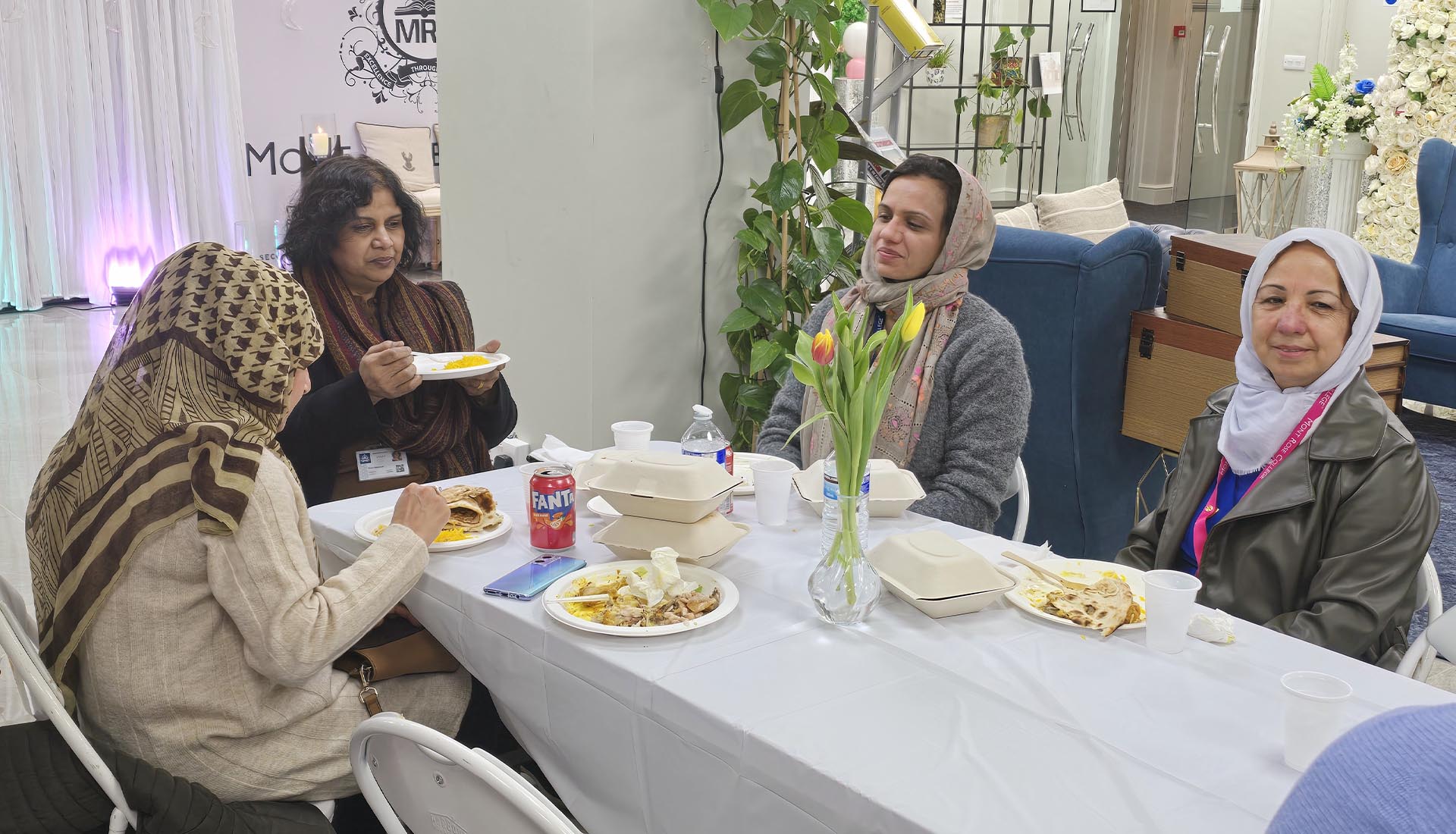 Guests enjoying a meal together at the Iftar Dinner at Mont Rose College, fostering a warm and communal atmosphere.
