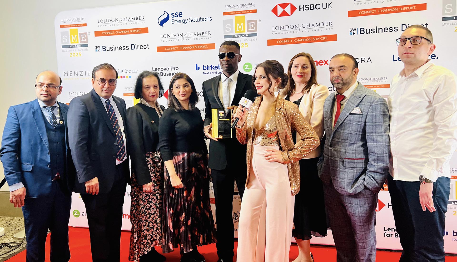 Mont Rose College team posing with their award at the SME London Chamber of Commerce Awards 2025, during a red carpet interview.