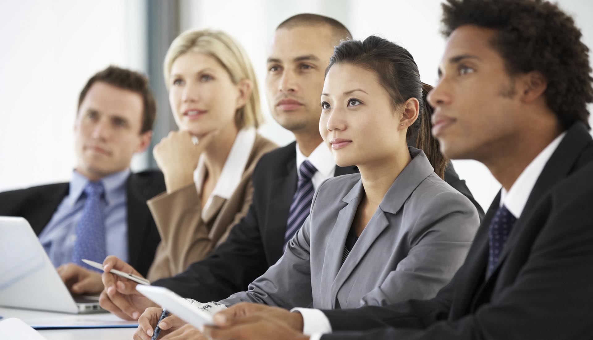 Group of professionals attentively listening during a presentation, highlighting industry relevant curriculum in HND courses.