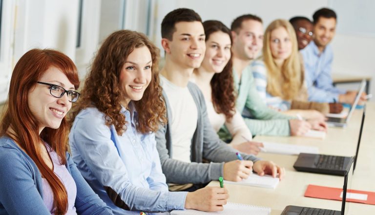 Students attentively learning in a classroom setting, representing comparison of educational paths like HND vs NVQ.