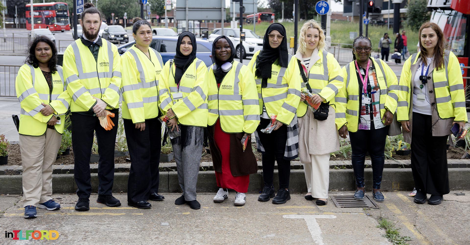 Group of volunteers in high-visibility jackets posing during Ilford Green Action Day community event.