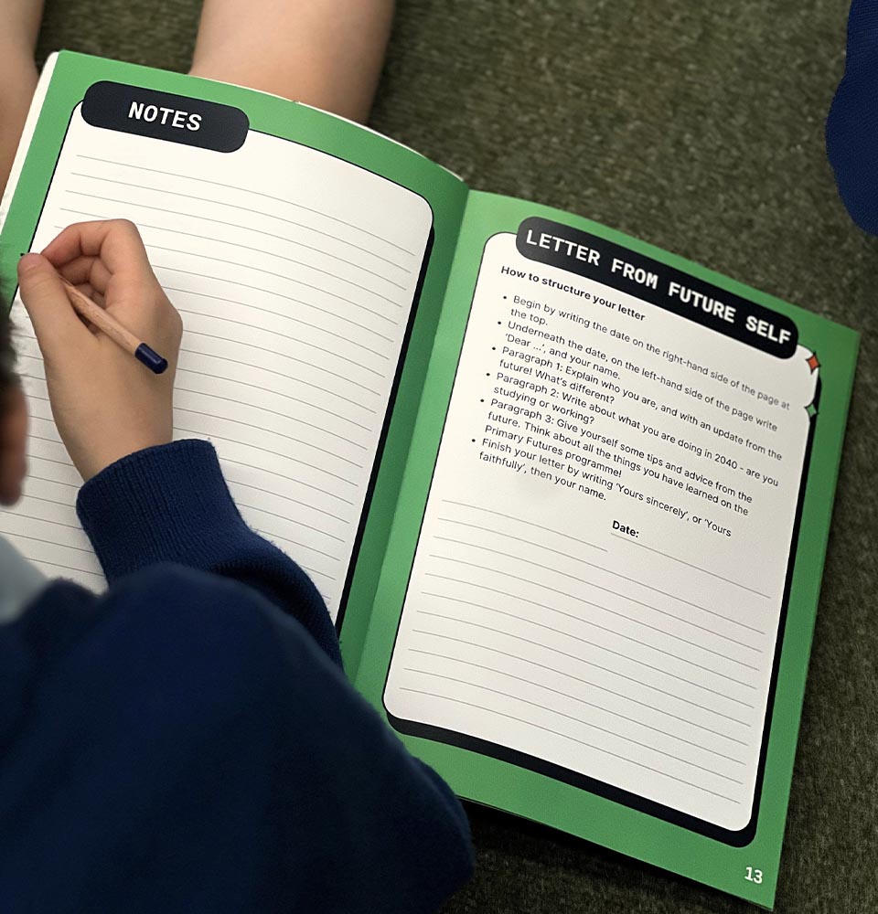 Student writing in a workbook titled 
