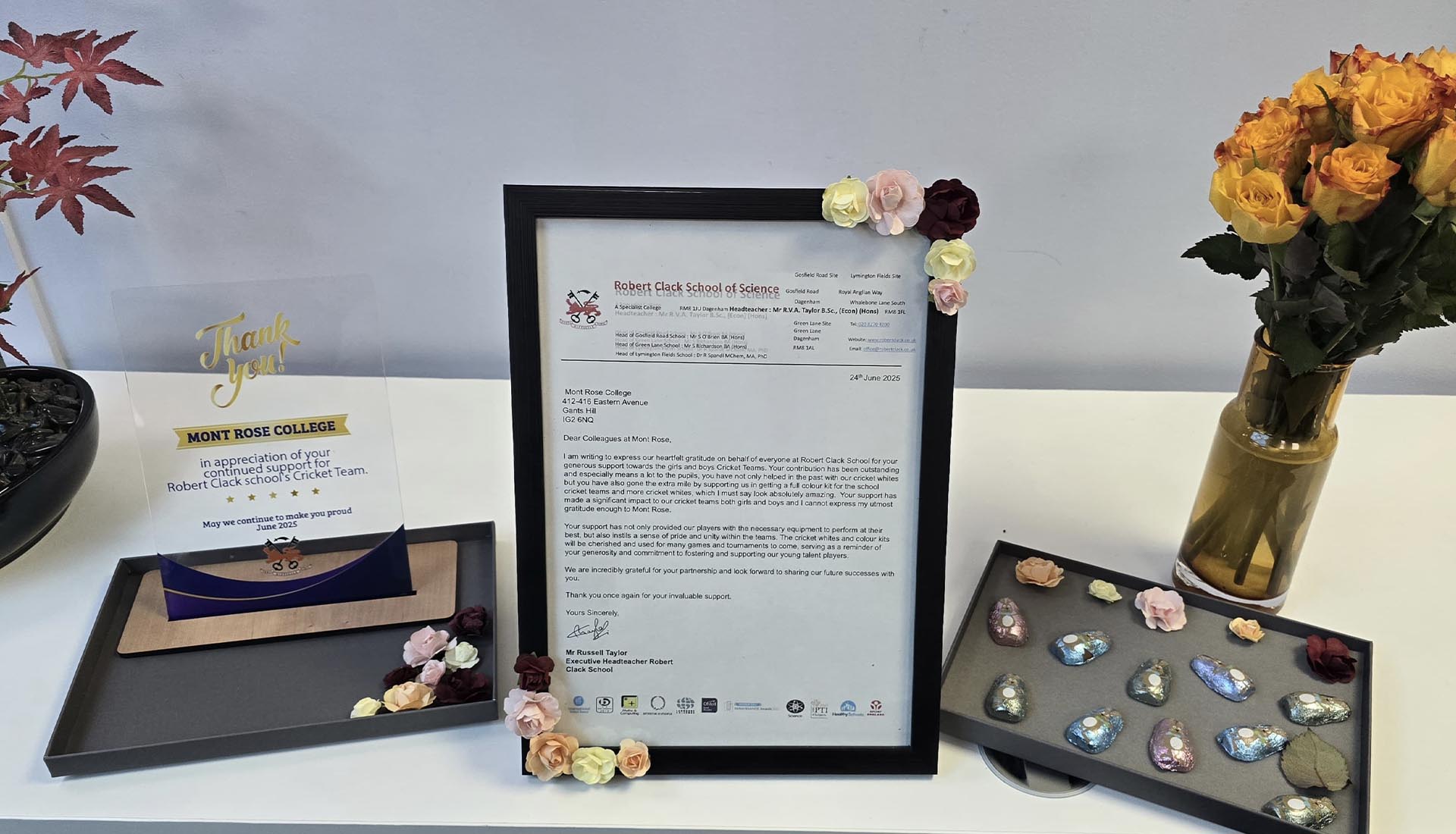 Appreciation display featuring thank-you plaque and letter celebrating student empowerment from Robert Clack School to Mont Rose College.