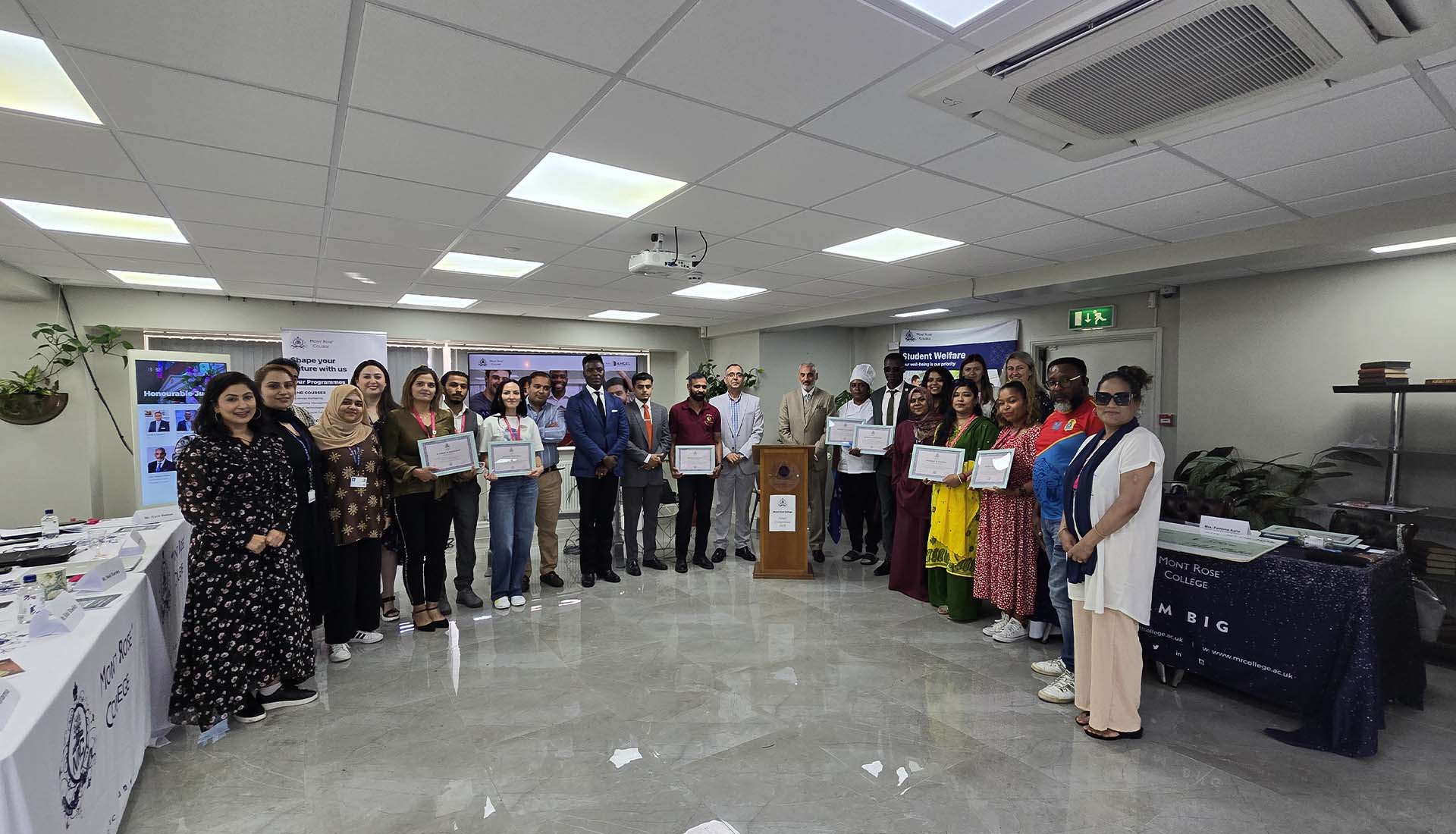 Group photo of participants and winners holding certificates at Mont Rose College during the Angel Competition award ceremony.