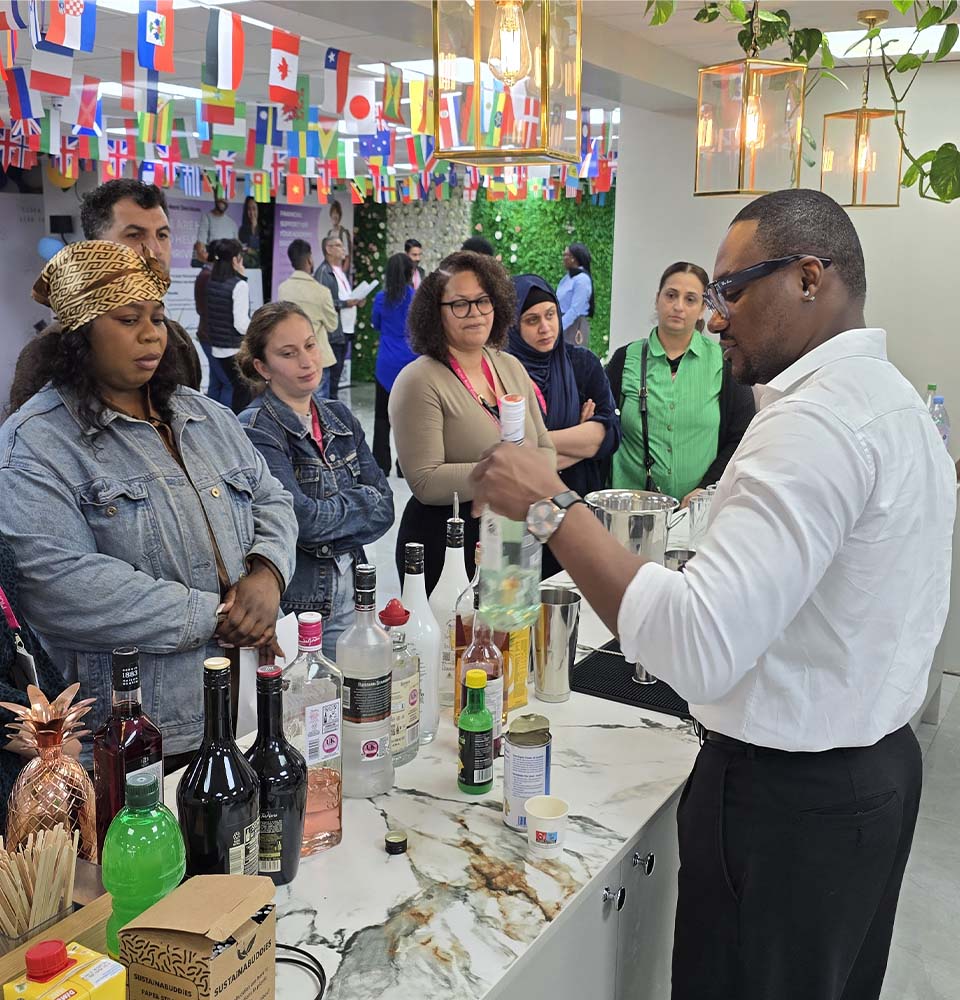 Instructor demonstrating drink preparation techniques to attendees during the Hospitality Skills Event at Mont Rose College.