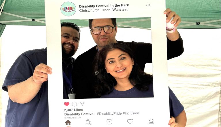 Three people smiling through a social media-style frame at the Disability Fair, promoting inclusion and disability pride.