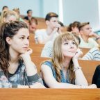 University students seated in a lecture hall, attentively listening, representing HND and other qualifications in higher education.