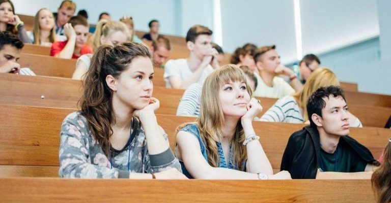 University students seated in a lecture hall, attentively listening, representing HND and other qualifications in higher education.