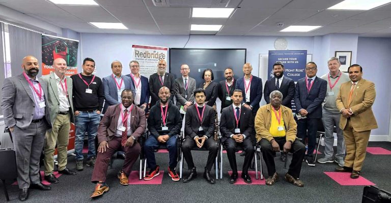 Group of professionals posing at Redbridge Chamber of Commerce meeting, highlighting networking and business collaboration.