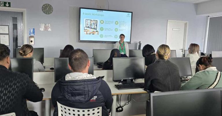 Students attending an Energise Programme session at Mont Rose College, with presenter explaining a 4-week workshop on screen.