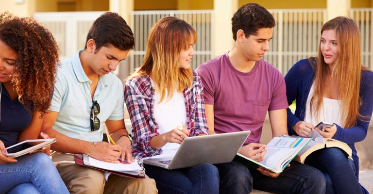 Students studying together with books, laptops, and tablets, representing alternative entry pathways for HND program.