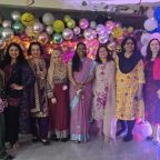Female staff dressed in traditional attire posing with festive decorations and balloons as Mont Rose College celebrates Diwali.