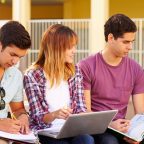 Group of diverse students sitting outdoors, studying together with books, laptop, and notes, representing collaborative learning and preparation for HND admissions.